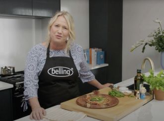 Nici Wickes wearing a Belling apron in a kitchen