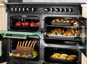 4 cavity range cooker with all the doors open revealing several cooked dishes inside