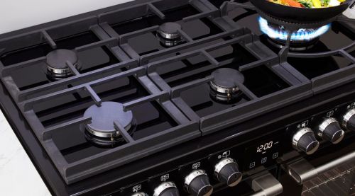 A Belling Cooktop with a stirfry cooking in a wok on a gas ring