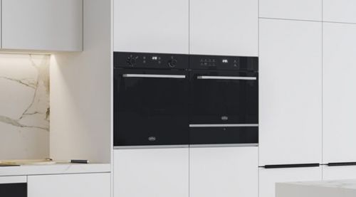 A black Commercial Microwave Oven installed in a white kitchen