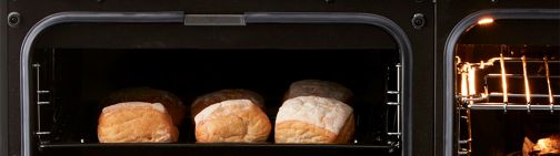 Homemade bread rolls baking in the small conventional oven