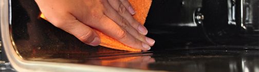 Wiping the inside of the oven with a cloth